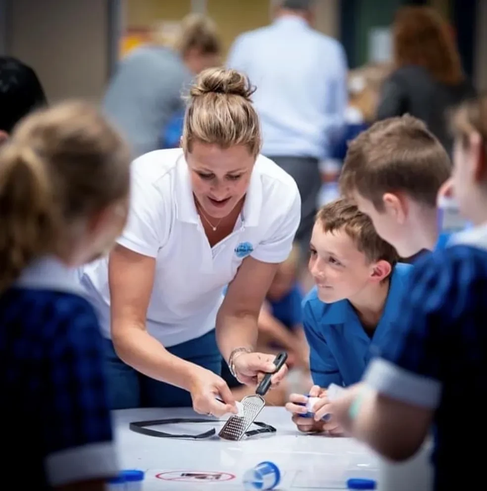 Ten Little Pieces instructor working hands-on with children on sustainability activities